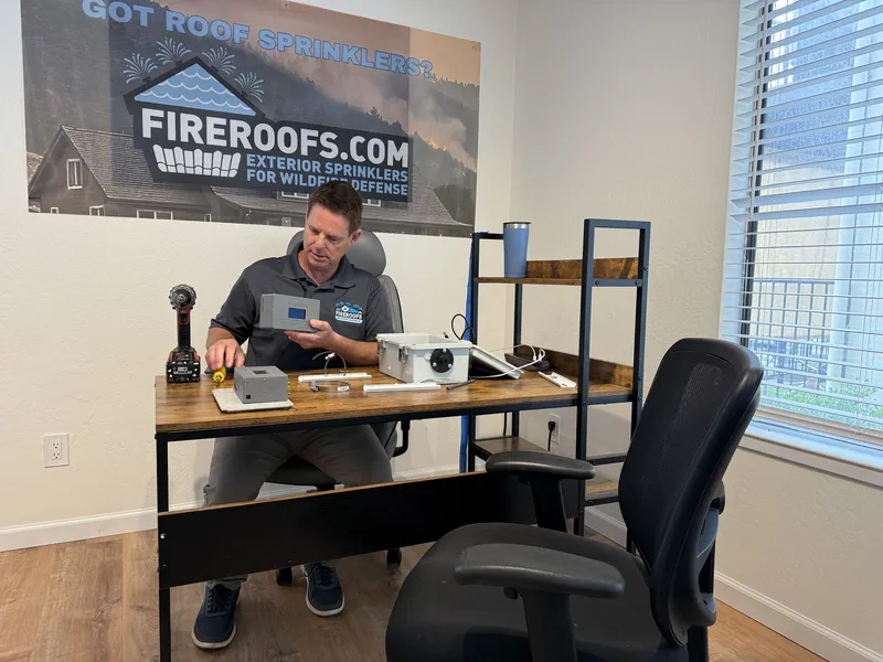 FireRoofs co-founder assembling wildfire defense control systems at headquarters