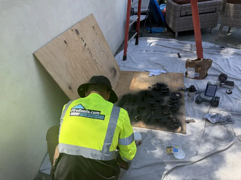 FireRoofs technician preparing commercial-grade sprinkler fittings on site
