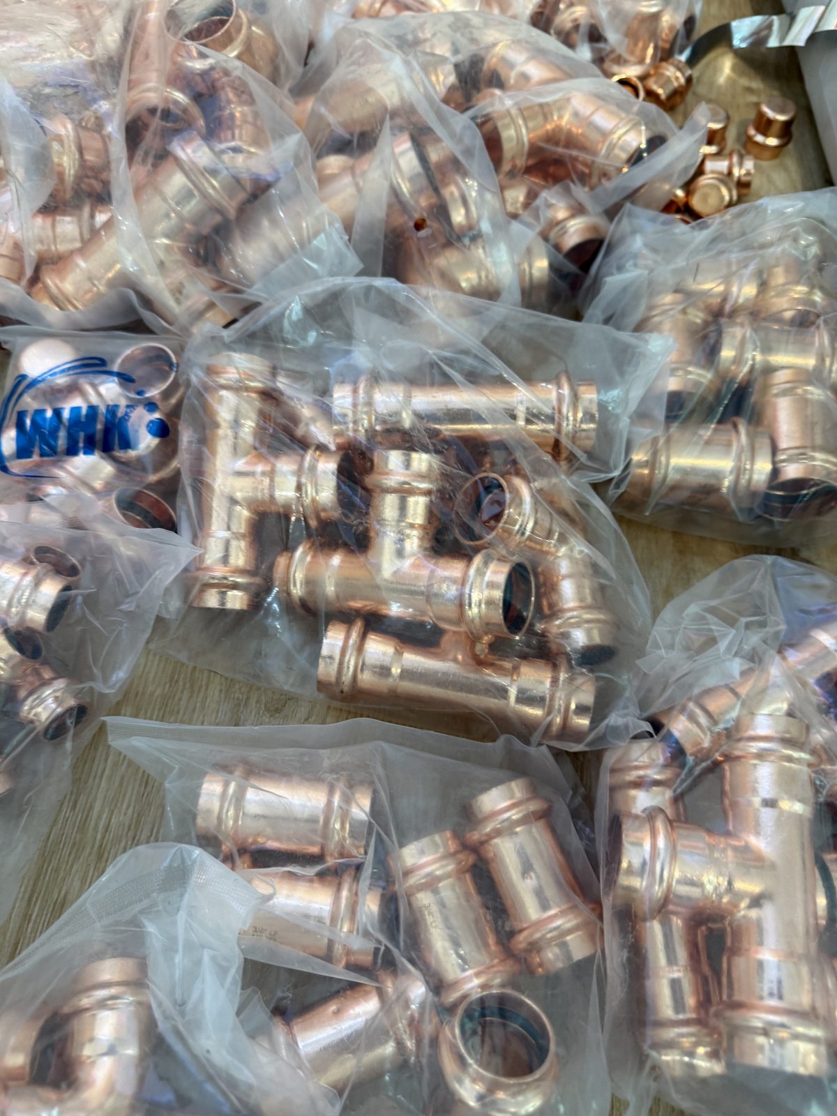 Close-up of copper press fittings used in FireRoofs all-copper wildfire sprinkler systems