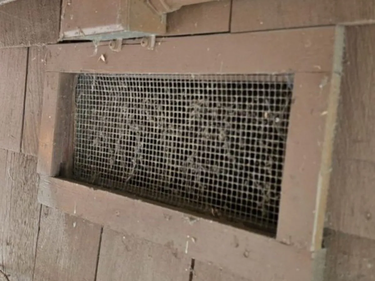 Original crawlspace vent on a Portola Valley home open to ember entry