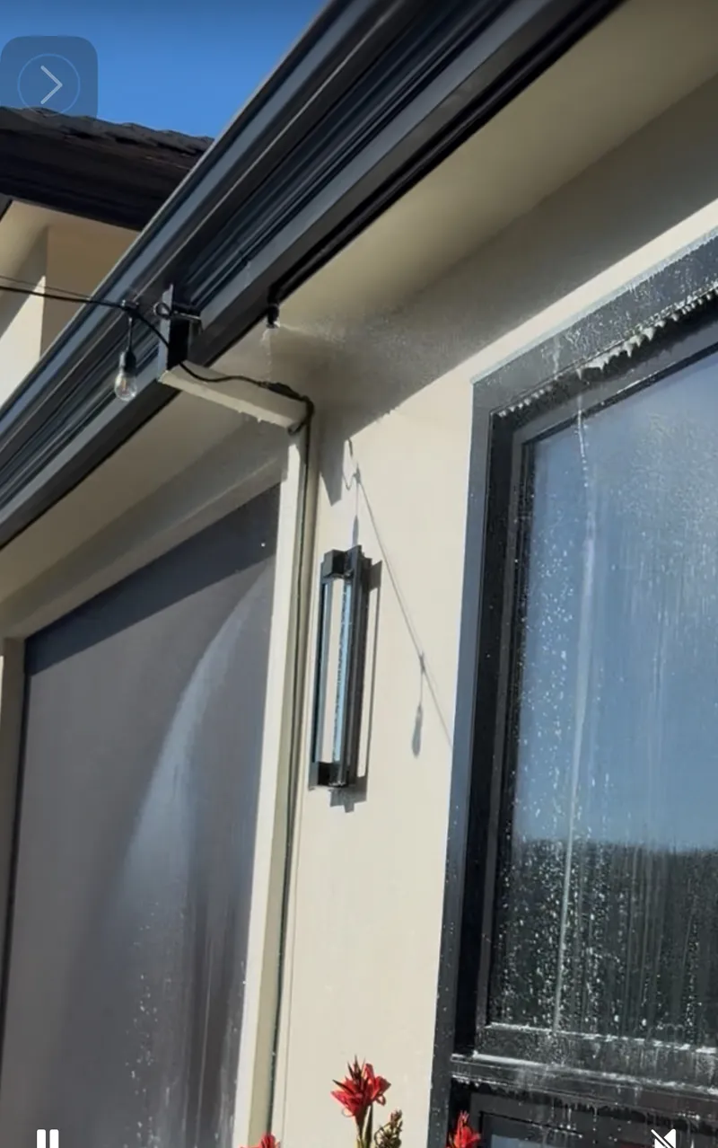 Eave-mounted sprinkler head protecting the soffit and fascia of a home