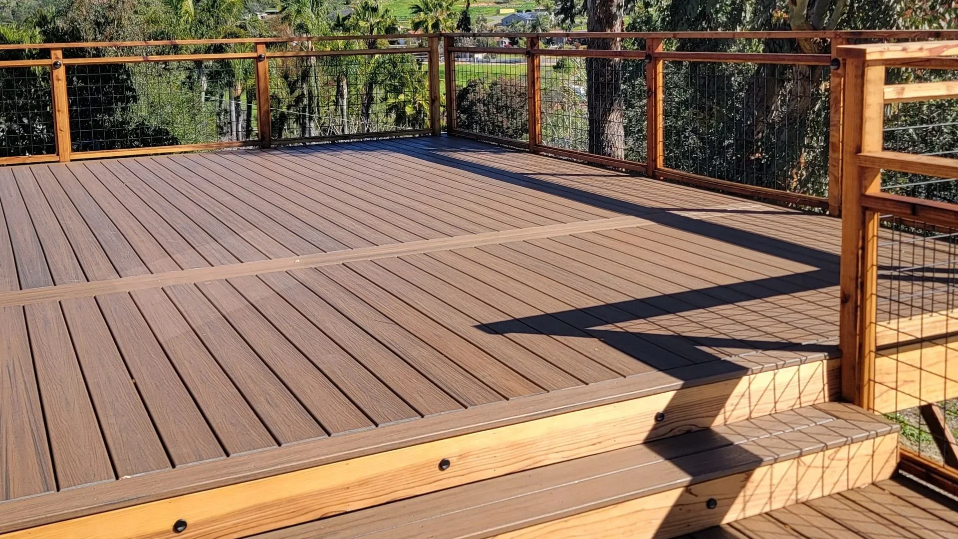 Fire-resistant PVC composite decking installed on a California home deck with mountain views