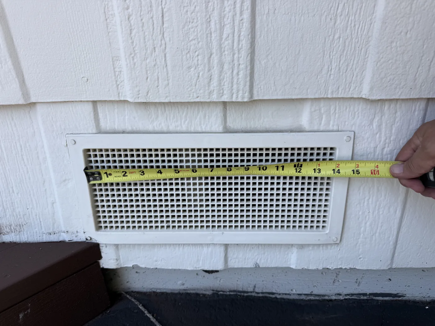 A standard foundation vent. Openings this size are far larger than the 1/16 to 1/8 inch needed to stop embers.