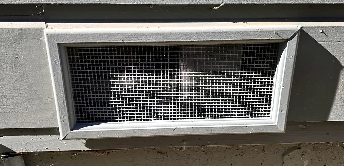 Crawlspace vent after fine ember-resistant mesh was added