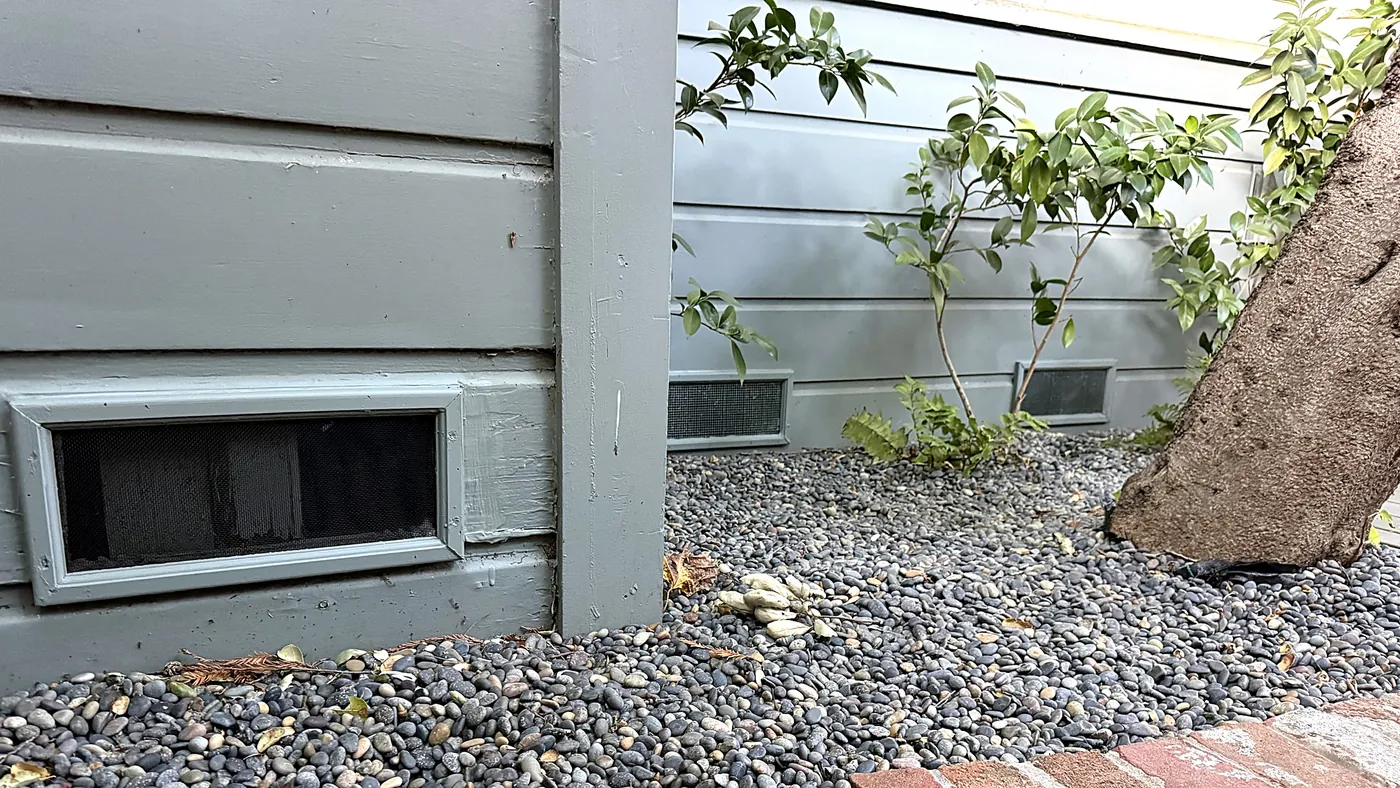 River rock in the first 5 feet around a Los Gatos home with screened foundation vents