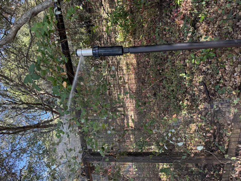 Perimeter sprinkler nozzle aimed at defensible space around a property