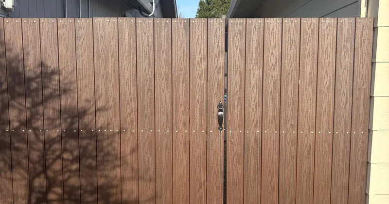 Fire-resistant fencing with non-combustible materials installed near a home exterior for wildfire protection