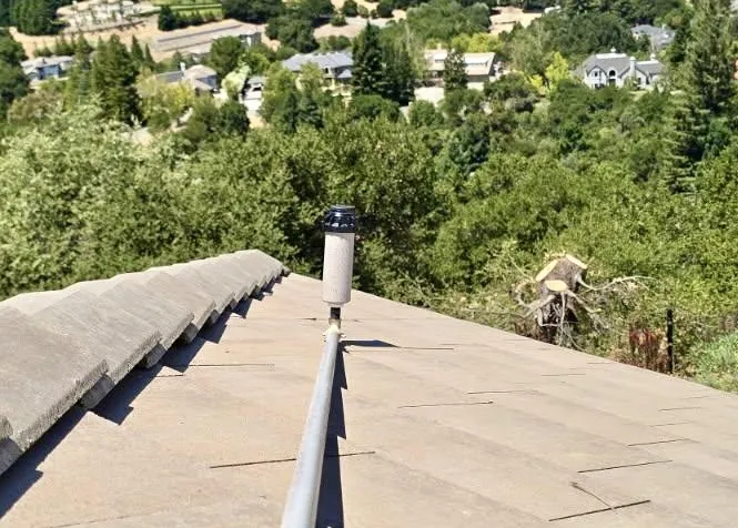 Close-up of a copper roof sprinkler head mounted on a ridge line