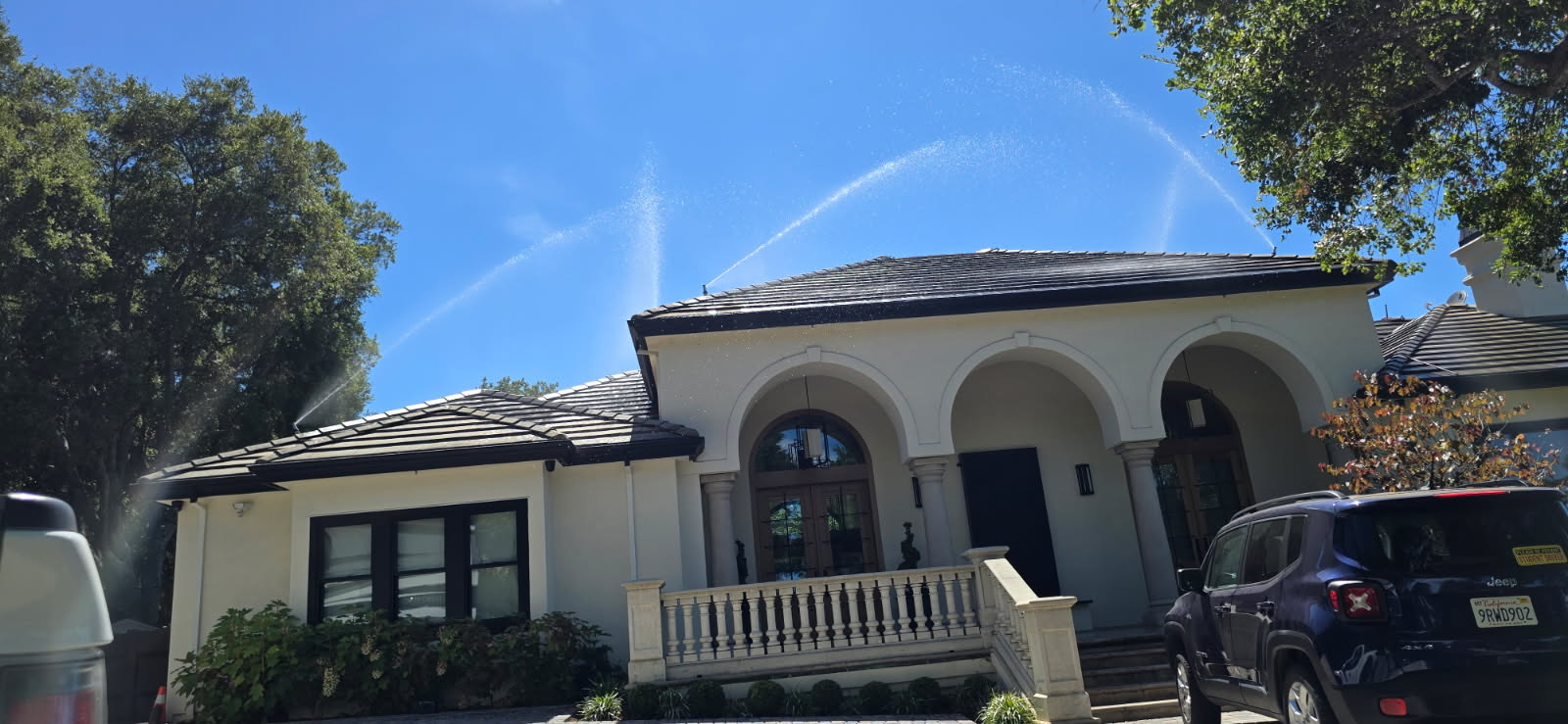 FireRoofs roof sprinklers in action covering entire luxury home exterior