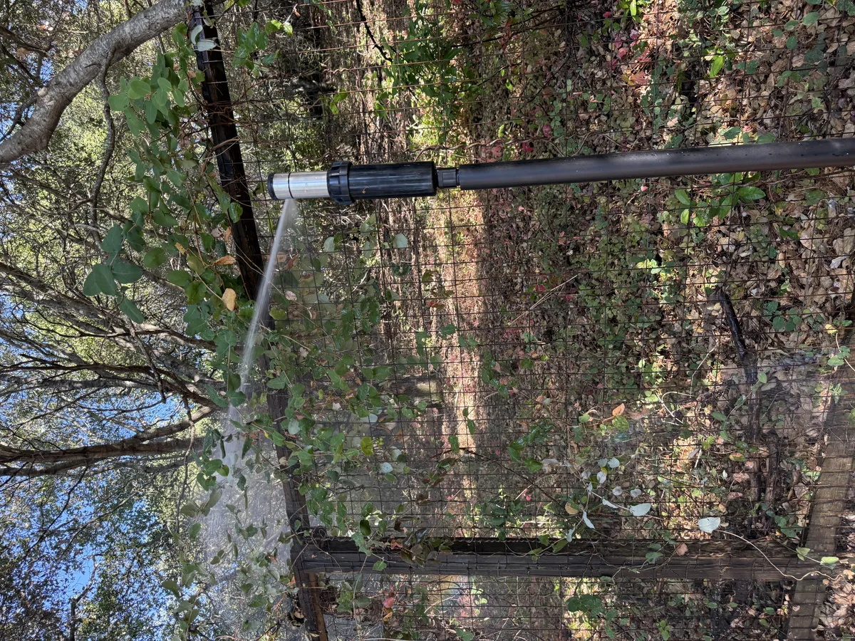 FireRoofs sprinkler nozzle saturating hillside perimeter on Bay Area property